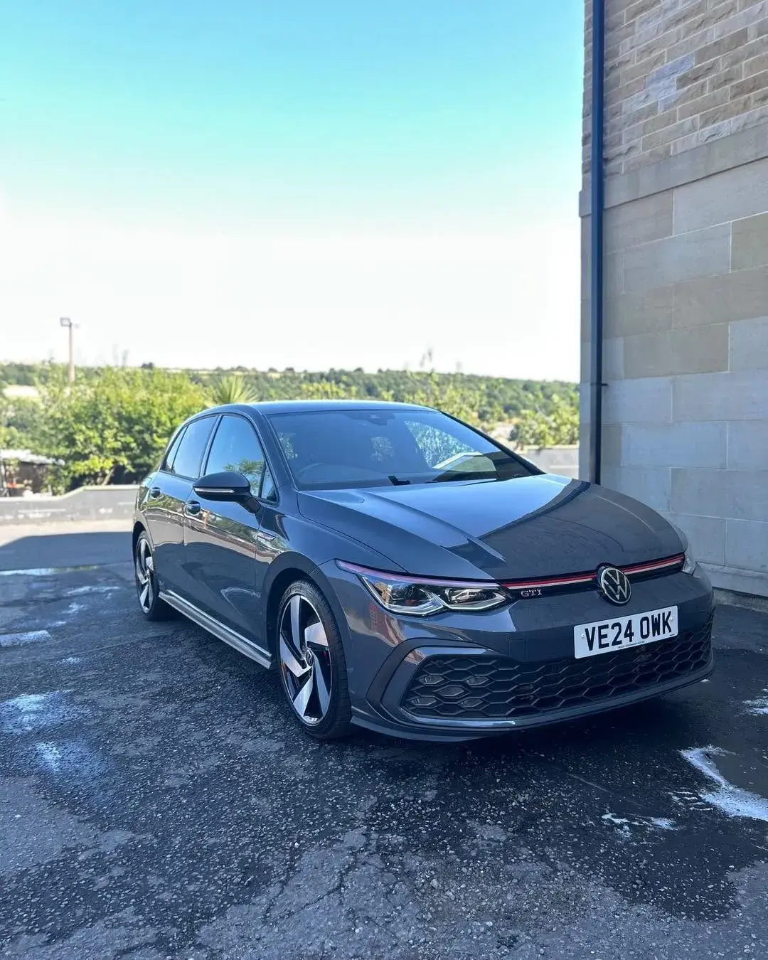 Grey hatchback gleaming after a valet