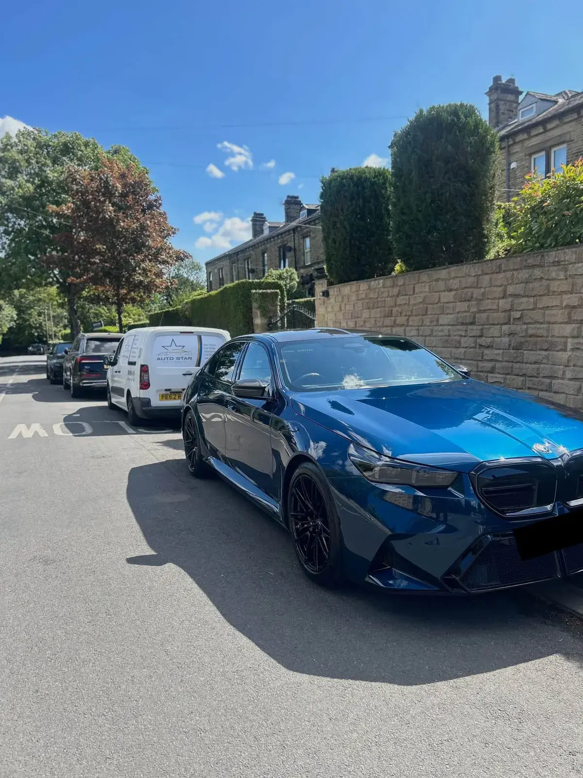 Blue hatchback gleaming after a wash